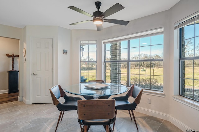 tiled dining room featuring ceiling fan