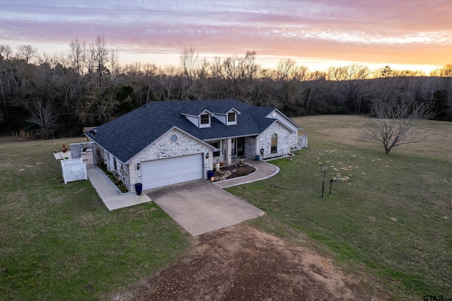 view of front of property featuring a yard and a garage