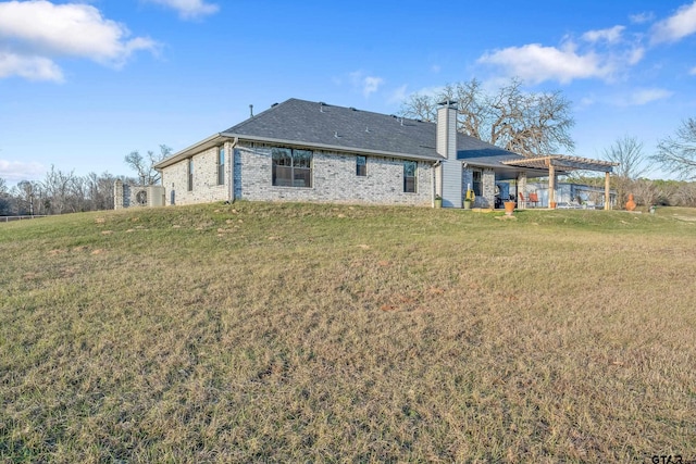 rear view of house featuring a lawn