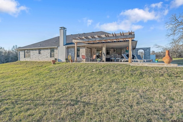 rear view of property featuring a pergola, a patio area, and a yard