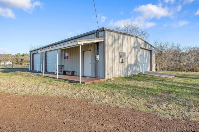 view of outdoor structure featuring a yard and a garage