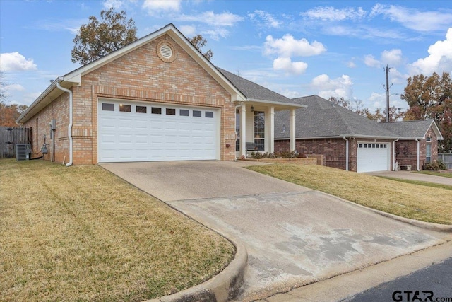 view of front facade with a front lawn, central AC unit, and a garage