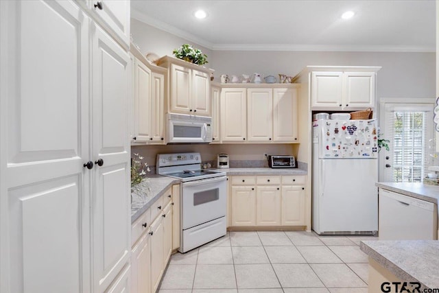 kitchen featuring cream cabinets, light tile patterned flooring, white appliances, and ornamental molding