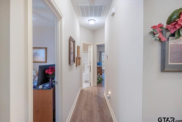 hall with light hardwood / wood-style floors