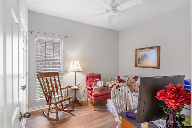 bedroom with ceiling fan, light hardwood / wood-style floors, and multiple windows