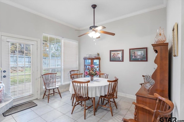 tiled dining room featuring crown molding and ceiling fan