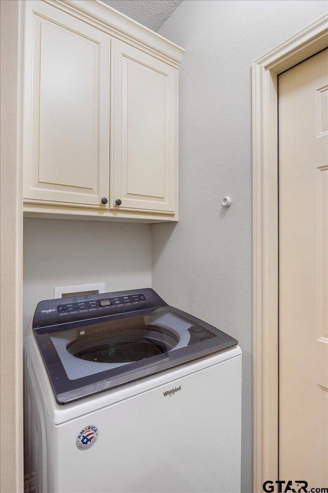 laundry room with cabinets and washer / dryer