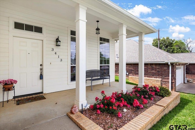 3413 Iberville Dr, Tyler, TX 75701 - entrance to property featuring covered porch, brick siding, and roof with shingles