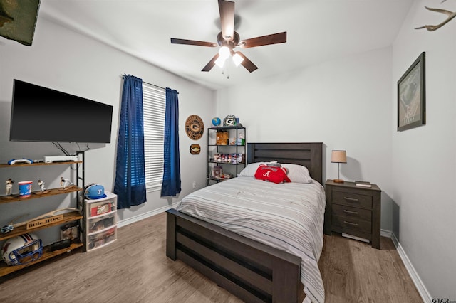 bedroom with ceiling fan and light hardwood / wood-style floors