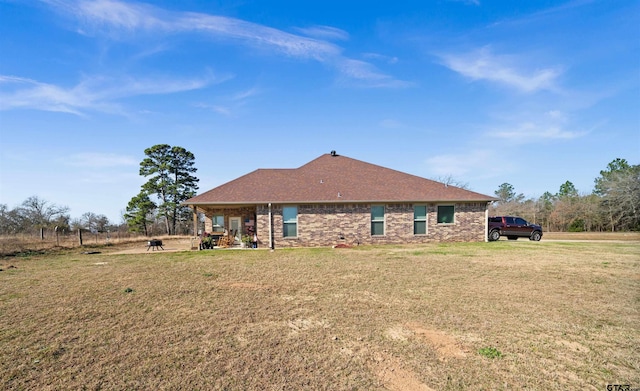 back of property featuring a lawn