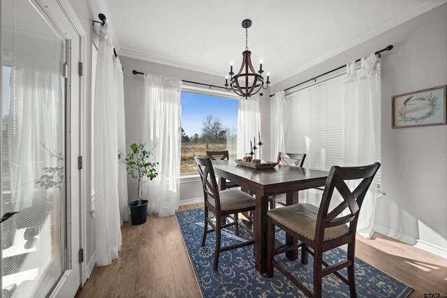 dining room with hardwood / wood-style flooring, a notable chandelier, and ornamental molding