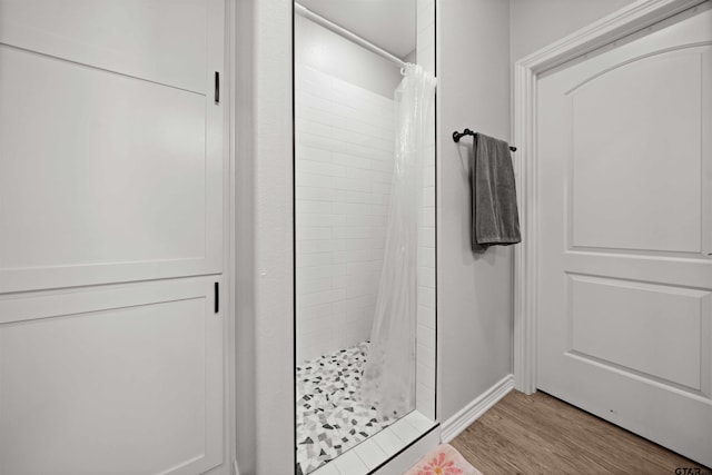 bathroom with a shower with curtain and hardwood / wood-style floors