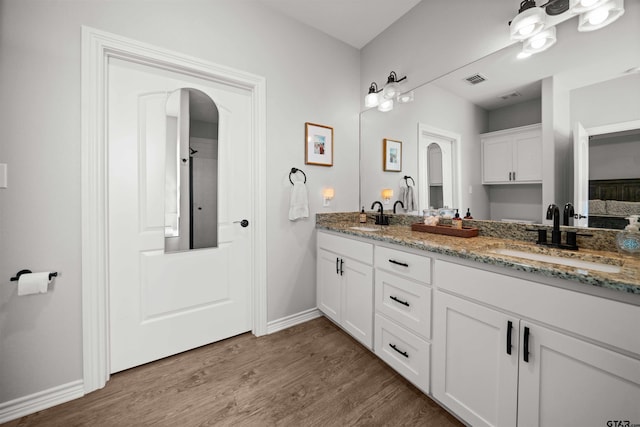 bathroom with hardwood / wood-style flooring and vanity