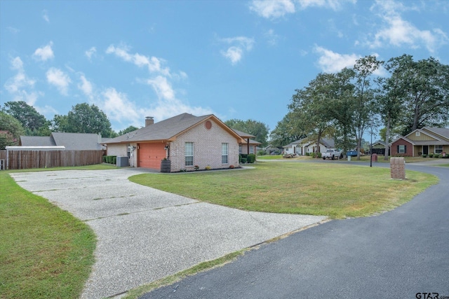 view of side of home featuring a yard, a garage, and central air condition unit