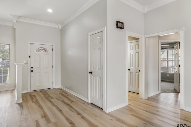 foyer featuring light hardwood / wood-style flooring and ornamental molding