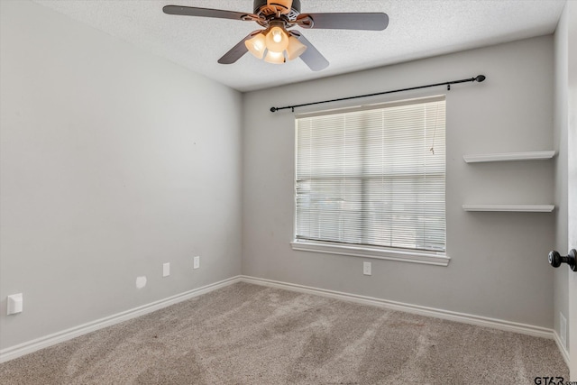 unfurnished room with carpet flooring, ceiling fan, and a textured ceiling