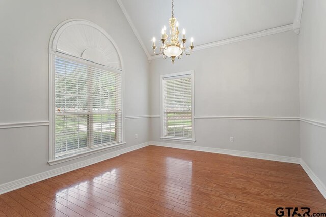 1213 Parkview Dr, Tyler, TX 75703 - unfurnished dining area featuring an inviting chandelier, wood finished floors, and baseboards