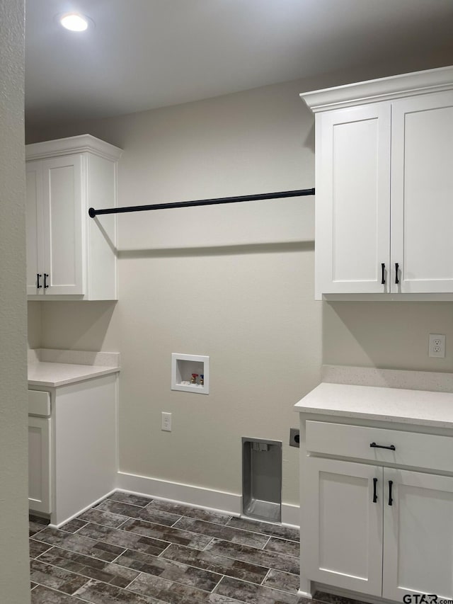 laundry area with cabinets, washer hookup, electric dryer hookup, and dark wood-type flooring