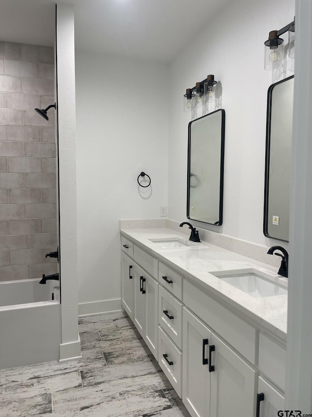 bathroom featuring vanity, hardwood / wood-style flooring, and tiled shower / bath