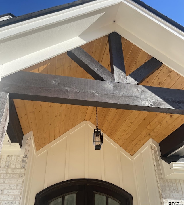 details with wood walls and wooden ceiling