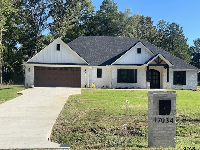 view of front of home with a garage and a front yard