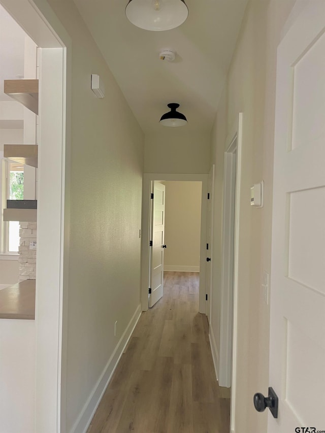 hallway with light hardwood / wood-style flooring