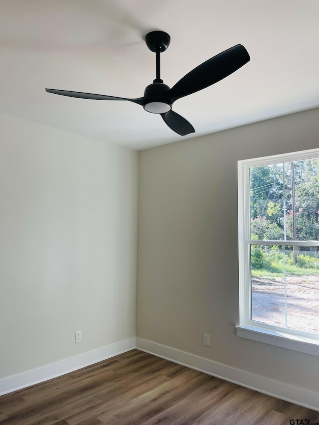 unfurnished room with ceiling fan and dark hardwood / wood-style floors