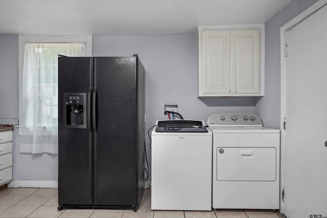 washroom with light tile patterned floors and washer and dryer