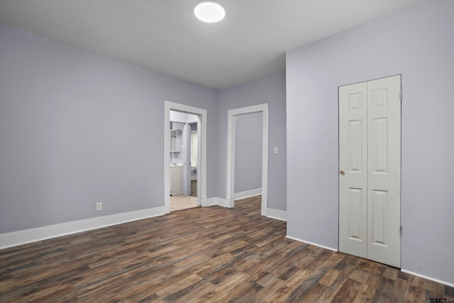 unfurnished bedroom featuring dark hardwood / wood-style floors