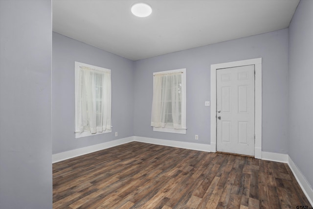 spare room featuring dark hardwood / wood-style flooring