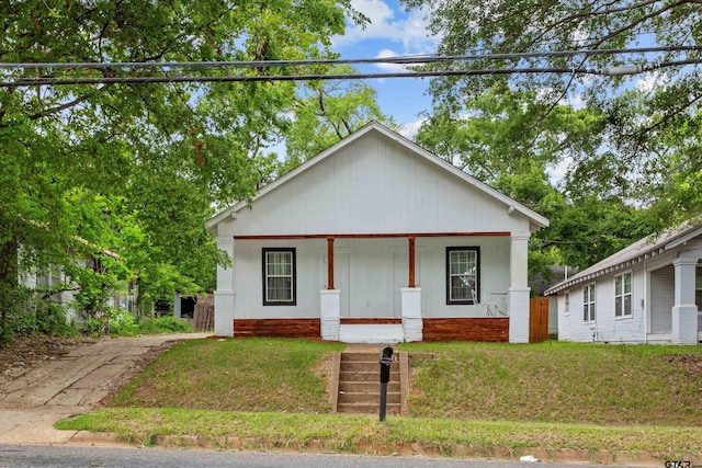 view of front of home featuring covered porch and a front yard