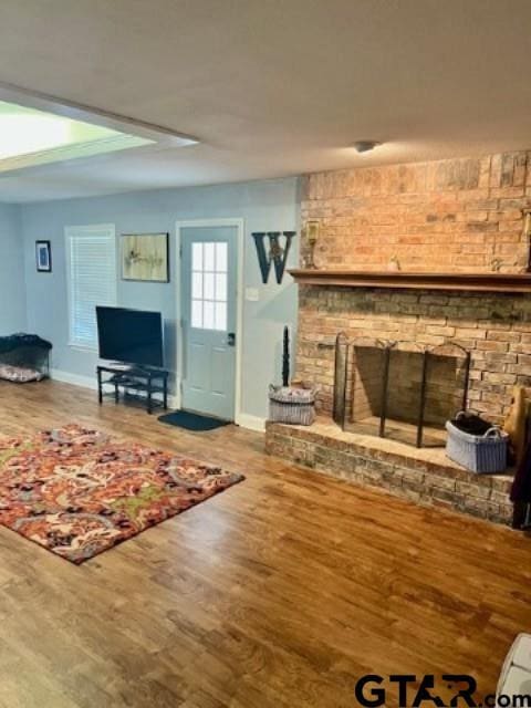 living room with hardwood / wood-style flooring and a fireplace