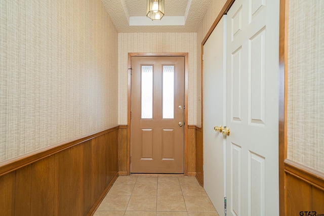 entryway featuring a textured ceiling and light tile patterned floors