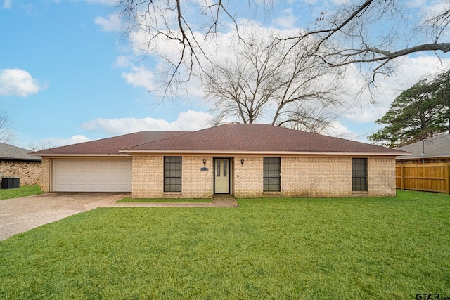 ranch-style house featuring a garage and a front yard