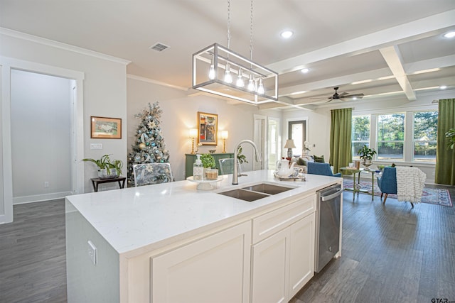 kitchen featuring sink, dishwasher, an island with sink, white cabinets, and decorative light fixtures