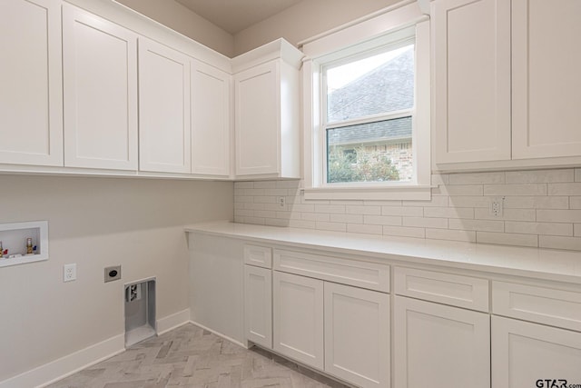 laundry room featuring cabinets, hookup for a washing machine, and electric dryer hookup