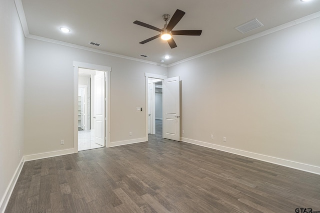 unfurnished bedroom with crown molding, dark hardwood / wood-style floors, connected bathroom, and ceiling fan