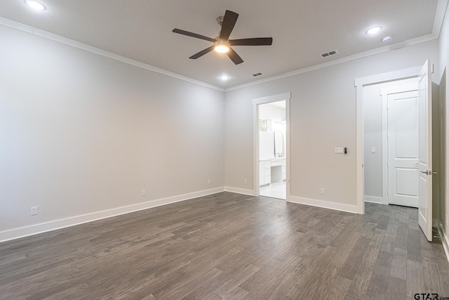 spare room featuring dark hardwood / wood-style flooring, crown molding, and ceiling fan