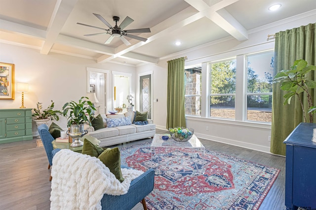 living room featuring hardwood / wood-style flooring, coffered ceiling, ceiling fan, crown molding, and beam ceiling