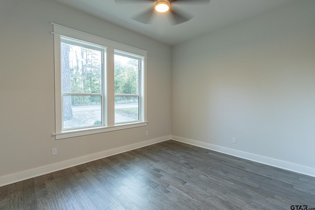 empty room with dark wood-type flooring and ceiling fan