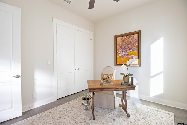 home office featuring dark wood-type flooring and ceiling fan