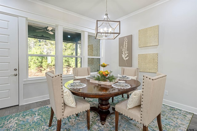 dining room with ornamental molding, dark hardwood / wood-style flooring, and a chandelier