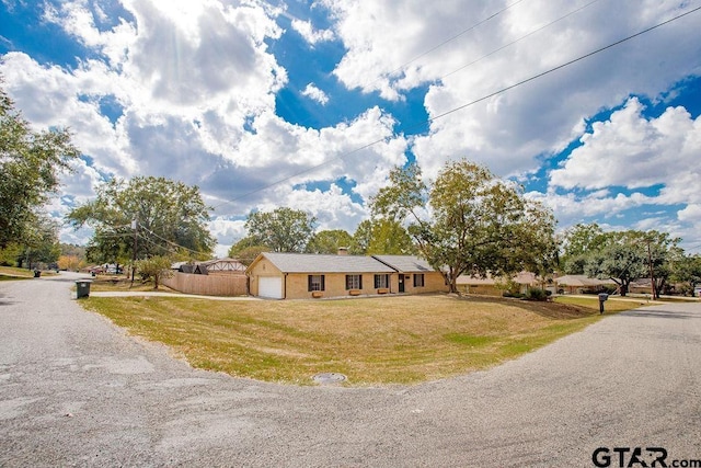 ranch-style home with a front yard