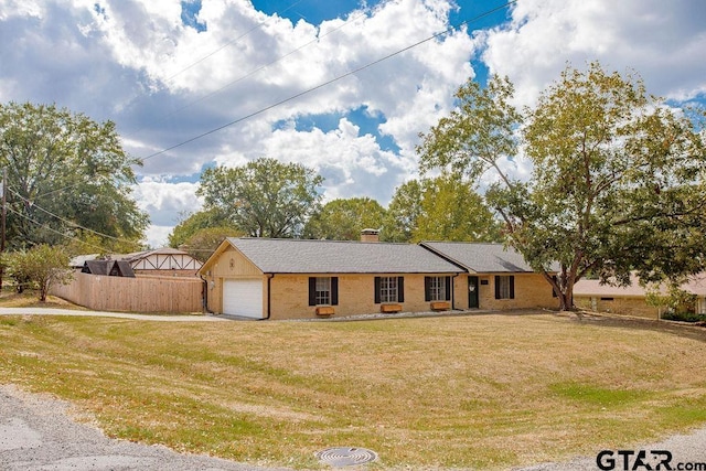 view of front facade featuring a garage and a front lawn