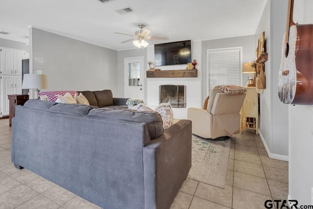 living room with ceiling fan and light tile patterned floors