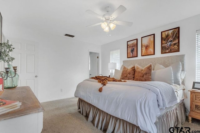 bedroom with ceiling fan and light colored carpet