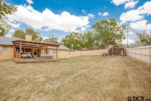 view of yard with a storage unit and a deck