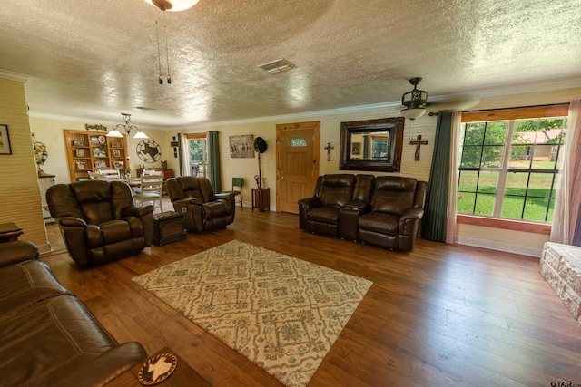 living room featuring hardwood / wood-style flooring, plenty of natural light, and a textured ceiling