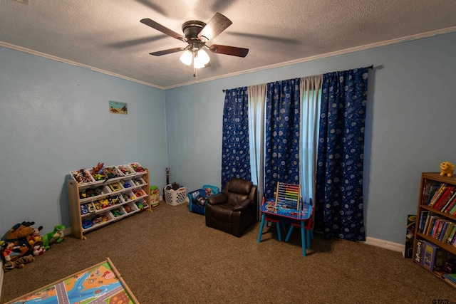 playroom featuring ornamental molding, carpet, a textured ceiling, and ceiling fan