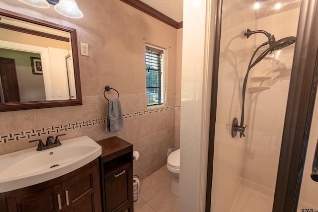 bathroom with crown molding, vanity, a textured ceiling, tile patterned flooring, and a shower